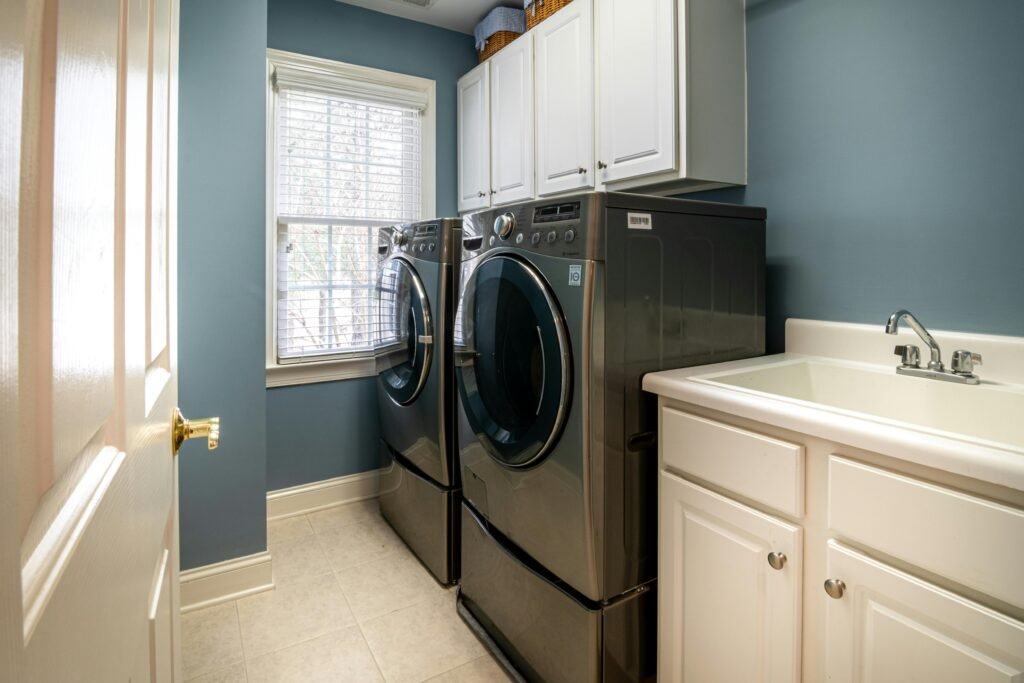 service-3 A clean, organized laundry room featuring modern appliances and ample storage.